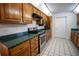 Galley style kitchen with wood cabinets and green countertops at 4915 Mount Pleasant Rd, Groveland, FL 34736