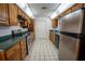 Kitchen features wood cabinets, stainless steel appliances, and green countertops at 4915 Mount Pleasant Rd, Groveland, FL 34736