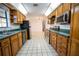 Open kitchen features wood cabinets, stainless steel appliances, and tiled floors at 4915 Mount Pleasant Rd, Groveland, FL 34736