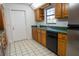 Kitchen with wood cabinets, green countertops, and stainless steel appliances at 4915 Mount Pleasant Rd, Groveland, FL 34736
