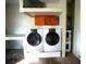Laundry room in garage includes washer, dryer, and overhead cabinets at 4915 Mount Pleasant Rd, Groveland, FL 34736