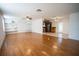 Spacious living room with hardwood floors, built-in shelving, and open kitchen at 4915 Mount Pleasant Rd, Groveland, FL 34736