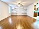 Bright living room featuring built-in shelving and wood floors at 4915 Mount Pleasant Rd, Groveland, FL 34736