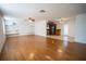 Spacious living room with hardwood floors, built-in shelving, and open kitchen at 4915 Mount Pleasant Rd, Groveland, FL 34736