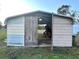 Metal storage shed with double doors, offering secure storage space at 4915 Mount Pleasant Rd, Groveland, FL 34736