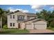 Two-story house with stone accents and a three-car garage at 2007 Shaggy Fisher Dr, Apopka, FL 32712