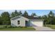 Single-story home with light blue exterior, white garage door, and landscaped lawn at 825 Hour Glass Rd, Lakeland, FL 33801