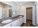 Main bathroom with double vanity, gray countertop and walk-in closet at 1106 Foreshore Ln, Haines City, FL 33844