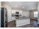 Modern kitchen with white cabinets, gray countertops, and stainless steel appliances at 1106 Foreshore Ln, Haines City, FL 33844