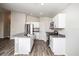 Modern kitchen with island, white cabinets, and gray countertops at 1106 Foreshore Ln, Haines City, FL 33844