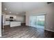 Open living space with wood-look floors and access to patio at 1106 Foreshore Ln, Haines City, FL 33844