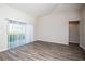Living room with wood-look floors and sliding glass doors at 1106 Foreshore Ln, Haines City, FL 33844