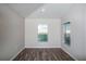Bright office space with wood-look flooring and two large windows at 1106 Foreshore Ln, Haines City, FL 33844