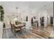 Open concept dining room with wood floors and view into living room at 3805 Sw 115Th St, Ocala, FL 34476
