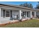 Front porch features rocking chairs and landscaping at 3805 Sw 115Th St, Ocala, FL 34476