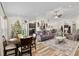 Open concept living room and dining area with gray sofas and Christmas tree at 3805 Sw 115Th St, Ocala, FL 34476