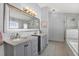 Bathroom with double vanity, large mirror, and walk-in shower at 1771 Turtle Rock Dr, Lakeland, FL 33803
