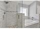 Updated bathroom features a walk-in shower and soaking tub with modern finishes at 1771 Turtle Rock Dr, Lakeland, FL 33803