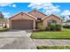 Beautiful one-story home with a two-car garage and well-manicured lawn at 1771 Turtle Rock Dr, Lakeland, FL 33803