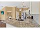 Kitchen island with granite countertop and stainless steel sink at 1771 Turtle Rock Dr, Lakeland, FL 33803