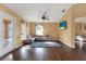 Living room with L-shaped sofa, wood floors, and access to patio at 1771 Turtle Rock Dr, Lakeland, FL 33803