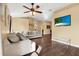 Bright and airy living room with hardwood floors and a large TV at 1771 Turtle Rock Dr, Lakeland, FL 33803