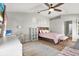 Main bedroom with king-size bed, workspace, and ceiling fan at 1771 Turtle Rock Dr, Lakeland, FL 33803