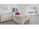 Bright bedroom with white bedding and a large window at 308 Kayden Cv, Winter Haven, FL 33884