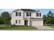 Two-story house with gray siding, black windows, and a two-car garage at 4160 Singing Mockingbird Blvd, Bartow, FL 33830