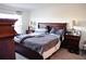 Spacious bedroom with a large bed and nightstands at 4694 Sigcom Pl, Wildwood, FL 34785