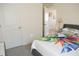 Bedroom with a bed and access to another room at 4694 Sigcom Pl, Wildwood, FL 34785