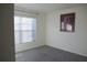 Bright bedroom with window and carpeted floor at 4694 Sigcom Pl, Wildwood, FL 34785
