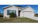 One-story house with a two-car garage and solar panels at 4694 Sigcom Pl, Wildwood, FL 34785