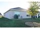 Rear view of house, showing AC unit and yard at 4694 Sigcom Pl, Wildwood, FL 34785
