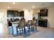 Modern kitchen with dark cabinets, granite counters, and stainless steel appliances at 4694 Sigcom Pl, Wildwood, FL 34785