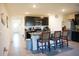 Modern kitchen with dark cabinets, granite counters, and stainless steel appliances at 4694 Sigcom Pl, Wildwood, FL 34785