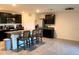 Modern kitchen with dark cabinets, granite counters, and stainless steel appliances at 4694 Sigcom Pl, Wildwood, FL 34785