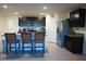 Modern kitchen with dark cabinets, granite countertops, and stainless steel appliances at 4694 Sigcom Pl, Wildwood, FL 34785
