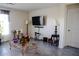 Living room featuring a large TV and comfortable seating at 4694 Sigcom Pl, Wildwood, FL 34785