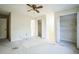 Carpeted bedroom with ceiling fan and double closets at 5325 Charlin Ave, Lakeland, FL 33810