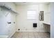 Laundry room with shelving, sink, and electrical panel at 5325 Charlin Ave, Lakeland, FL 33810