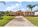 Attractive one-story house with a brick driveway and lush landscaping at 5508 Pebble Beach Dr, Lakeland, FL 33812