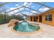 Large kidney shaped pool with screened enclosure at 5508 Pebble Beach Dr, Lakeland, FL 33812