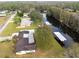 Aerial view of house and property by the lake at 6085 Amaryllis Dr, Indian Lake Estates, FL 33855
