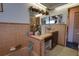 Retro bathroom with pink tile, double vanity, and bathtub at 6085 Amaryllis Dr, Indian Lake Estates, FL 33855