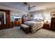 Spacious main bedroom with wooden furniture and carpeted floor at 6085 Amaryllis Dr, Indian Lake Estates, FL 33855