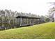 Covered boat dock with a wooden platform over calm water at 6085 Amaryllis Dr, Indian Lake Estates, FL 33855