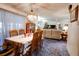 Dining area with table and chairs, offering views into the living room at 6085 Amaryllis Dr, Indian Lake Estates, FL 33855