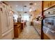 Retro kitchen with wood cabinets, tiled floor, and stainless steel appliances at 6085 Amaryllis Dr, Indian Lake Estates, FL 33855