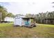 Lakefront storage shed with porch at 6085 Amaryllis Dr, Indian Lake Estates, FL 33855